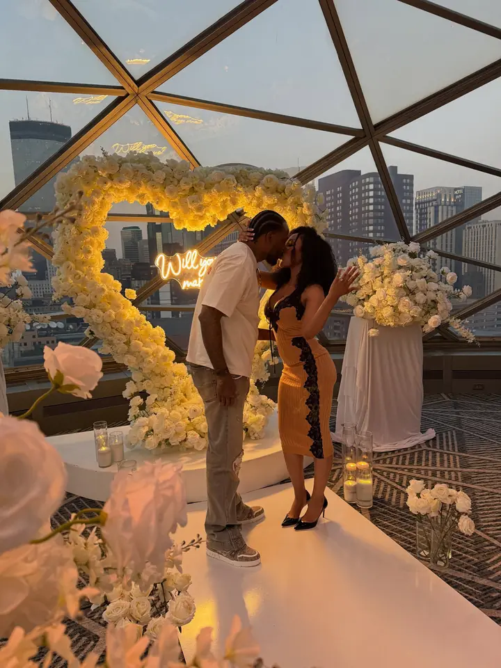 Floral heart proposal setup under a glass dome